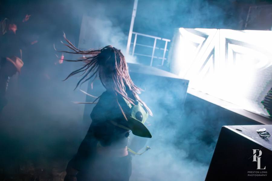 dancer in the smoke beside the booth at a Black Label Radio show